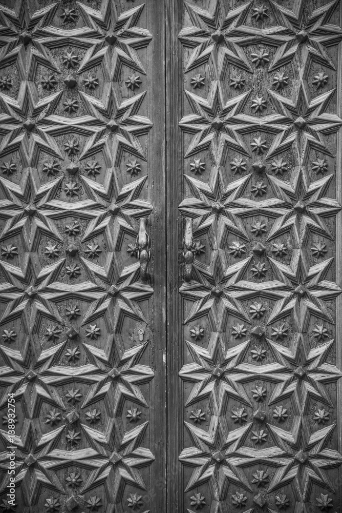 Closeup of ornate wooden medieval door in Sitges, Barcelona (Spain) Closeup of ornate wooden medieval door in Sitges, Barcelona (Spain)