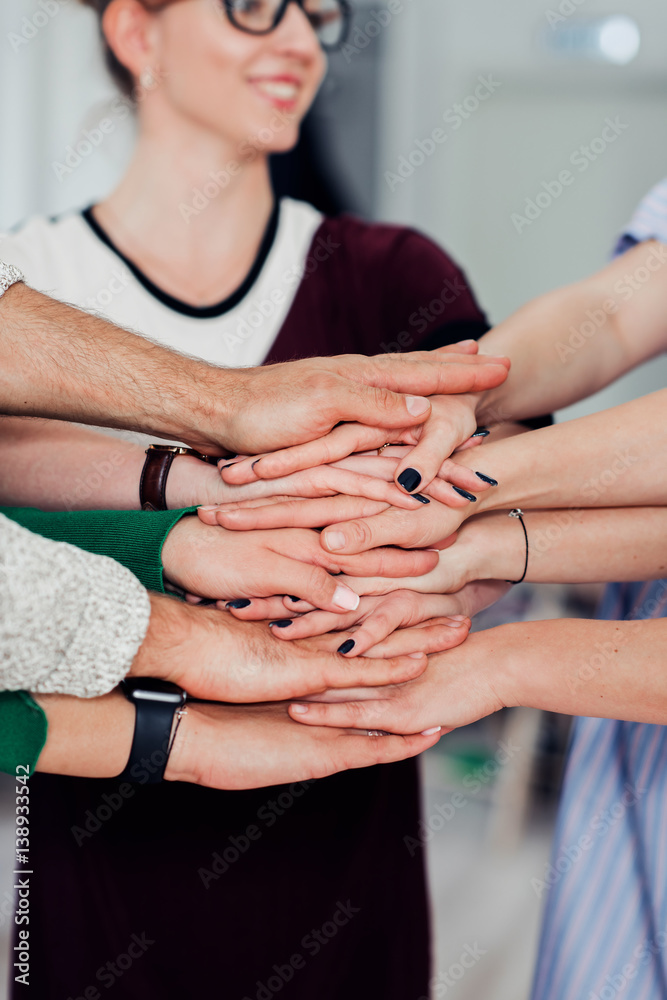 Fototapeta premium Strength in unity. Closeup shot of co-workers hand put together in an expression of unity and team spirit