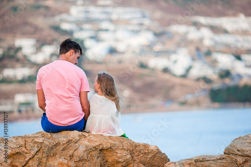 Family on vacation. Dad and girl on the beach in the evening