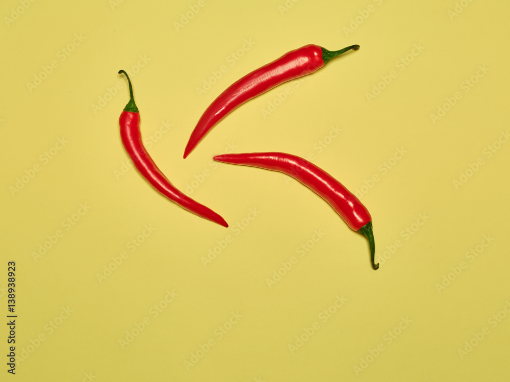bitter chili pepper and paprika on a yellow background bitter chili pepper and paprika on a yellow background