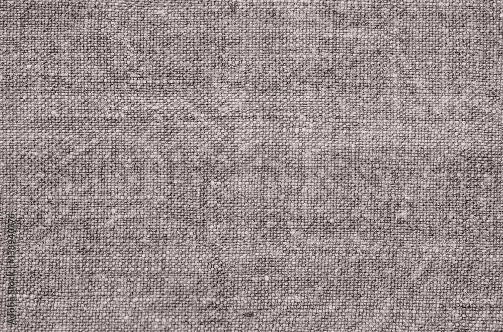 Homespun hemp cloth. Close-up of texture fabric cloth textile background. Homespun hemp fabric material. Homespun hemp canvas. Natural authentic cloth. Gray-green color