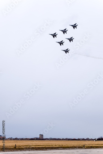 Air show in the sky above the Krasnodar airport flight school. Airshow in honor of Defender of the Fatherland. MiG-29 in the sky. photo