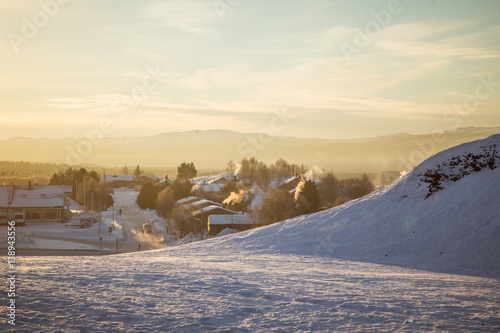 A beautiful morning panorama of a small Norwegian town during sunrise with a flares and warm look © dachux21