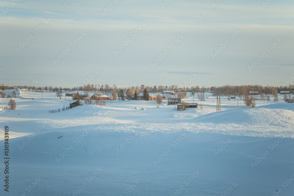 A beautiful morning panorama of a small Norwegian town during sunrise with a flares and warm look A beautiful morning panorama of a small Norwegian town during sunrise with a flares and warm look