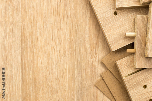 High Angle Close Up of Unfinished Wood Planks with Pegs and Holes - Background of Un-assembled Wooden Shelves with Copy Space photo