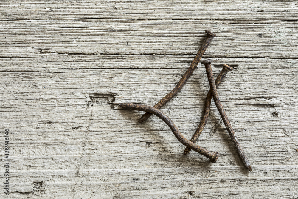 Obraz premium Rusty nails on wooden background