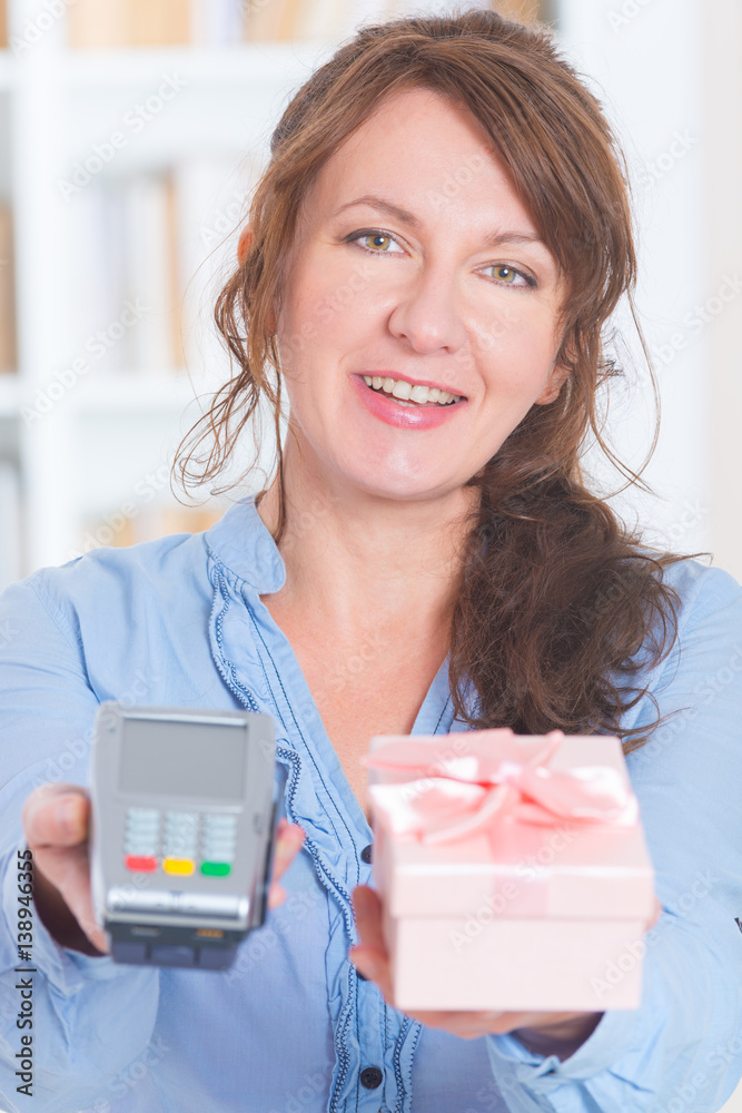 Seller holding payment terminal and goods