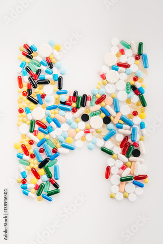 Top view of letter H made from medical pills and capsules  medicine and healthcare concept