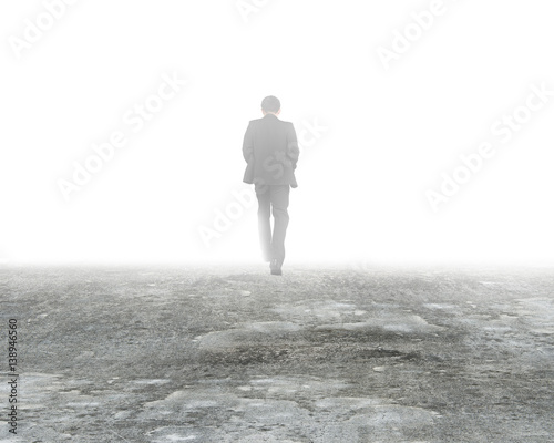 Man walking in mist on dirty concrete floor