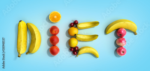  white plate with laid out on her word diet composed of slices of different fruits 3d render on blue