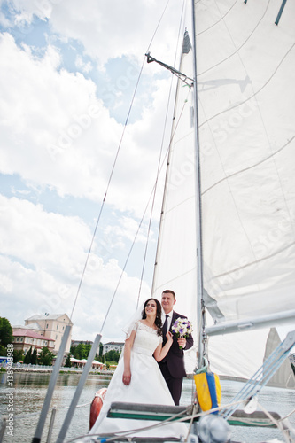 Wedding couple in love at small sailboat yacht on lake. © AS Photo Family