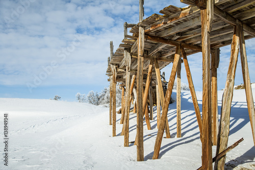 An old, abandoned copper mine building in the snowy Norway landscape