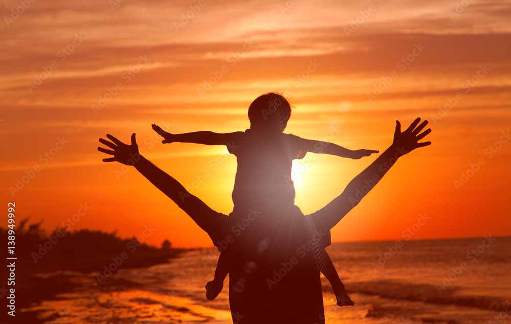 Fototapeta premium father and son having fun at sunset