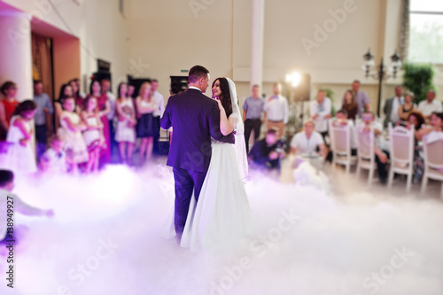 Awesome first wedding dance with smoke and rose purple lights. photo
