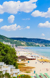 The Black Sea shore, blue clear water, beach with sand, umbrellas and sunbeds. Albena, Bulgaria