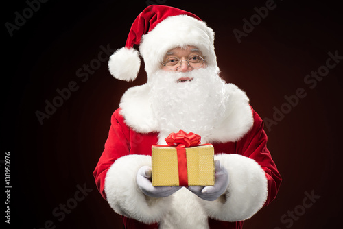 Santa Claus with gift box in hand