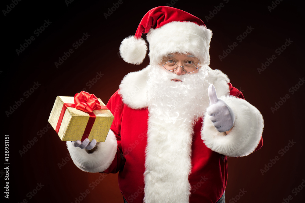 Santa Claus with gift box in hand Santa Claus with gift box in hand
