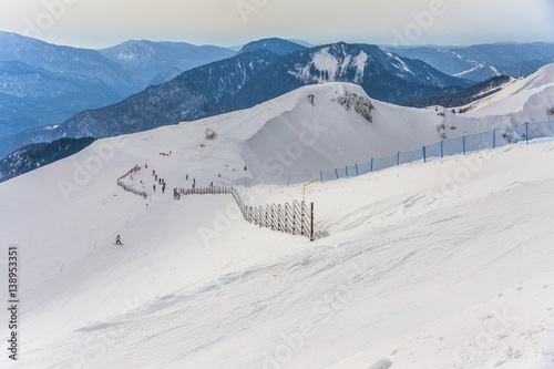 Obraz na płótnie Sochi Rosa Khutor snow-capped mountains skiers and snowboarders w salonie