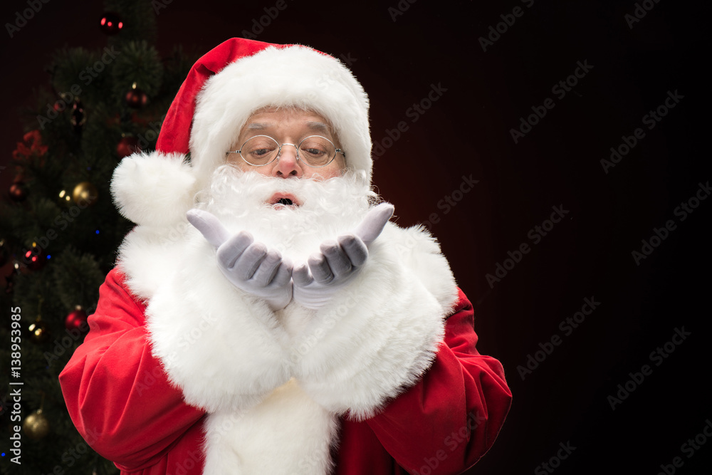 Santa Claus blowing snowflakes Santa Claus blowing snowflakes