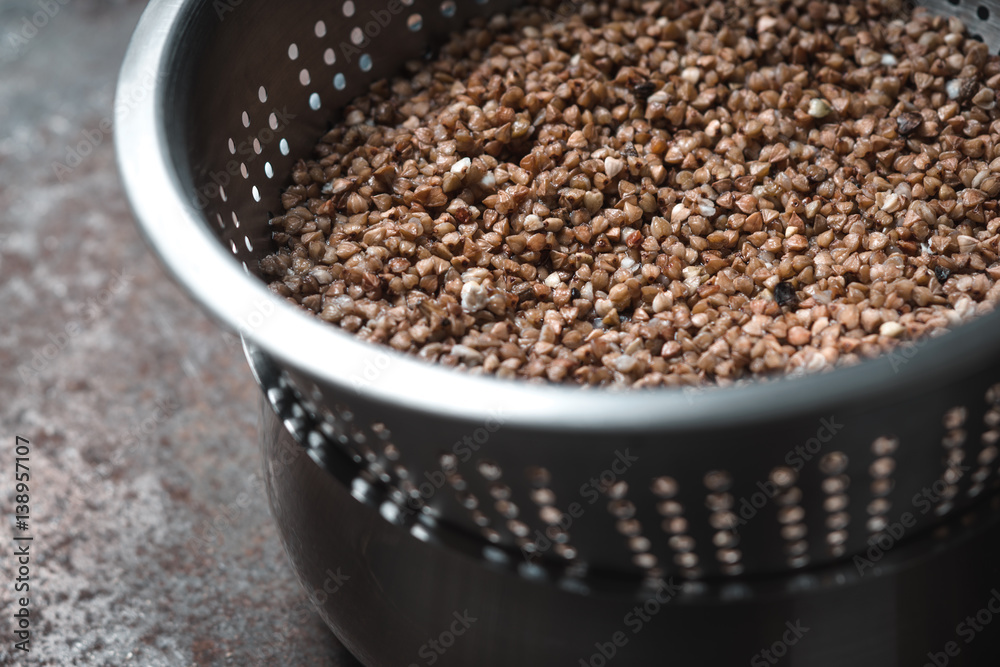 Buckwheat in the metal colander horizontal Buckwheat in the metal colander horizontal