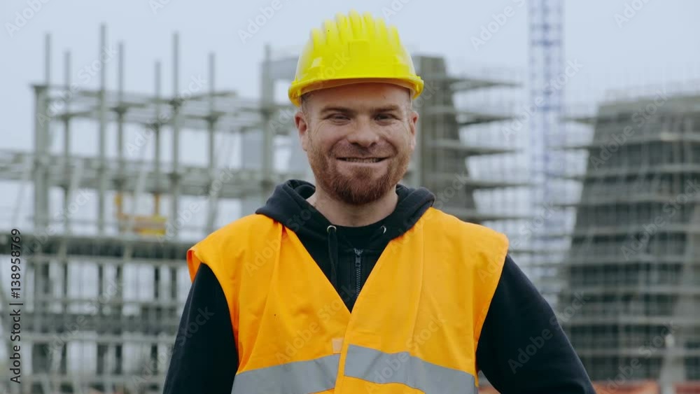Happy construction worker smiling at the camera Happy construction worker smiling at the camera