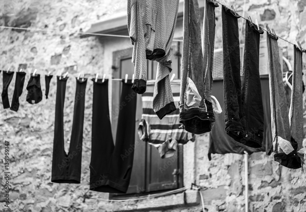 Naklejka premium Clothes hanging on ropes and drying