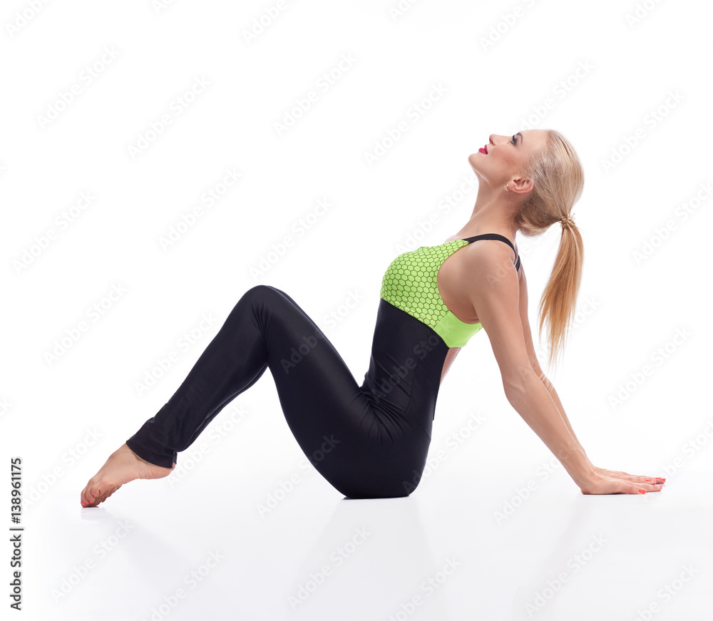 Gorgeous young woman practicing yoga sitting on the floor Gorgeous young woman practicing yoga sitting on the floor