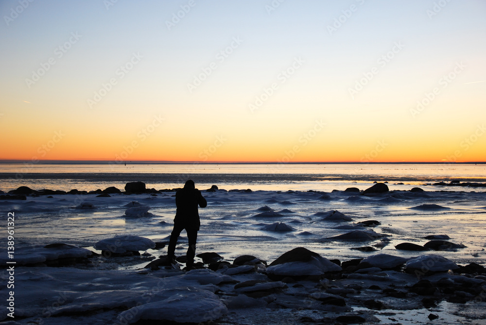 Icy coast with a man silhouette