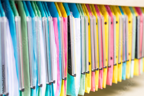 set of multi colored folders   files in metal enclosure   closet