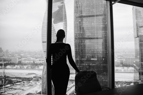 silhouette of a girl on the background of skyscrapers photo