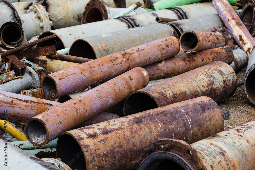 Pile of construction metals in factory. Steel tubes, iron pipes and bars.