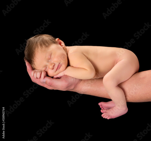 Small baby on fathers hand