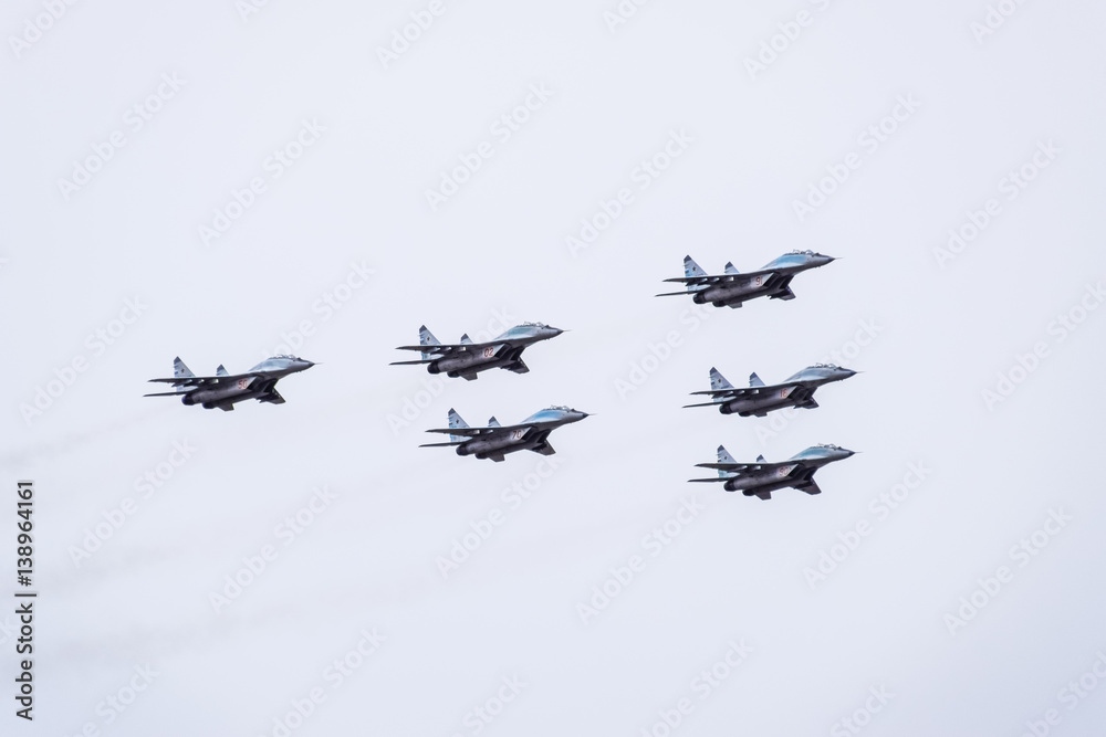 Air show in the sky above the Krasnodar airport flight school. Airshow in honor of Defender of the Fatherland. MiG-29 in the sky. Air show in the sky above the Krasnodar airport flight school. Airshow in honor of Defender of the Fatherland. MiG-29 in the sky.