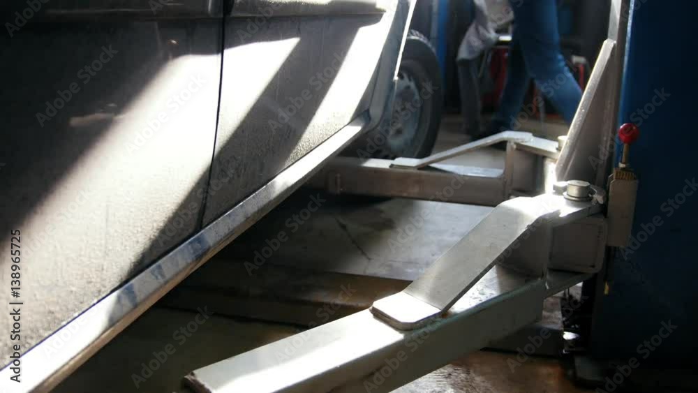 Car service station - part of lift platform with repairing auto Car service station - part of lift platform with repairing auto
