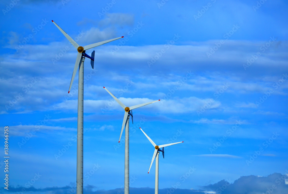 Wind turbine generating electricity on blue sky Wind turbine generating electricity on blue sky
