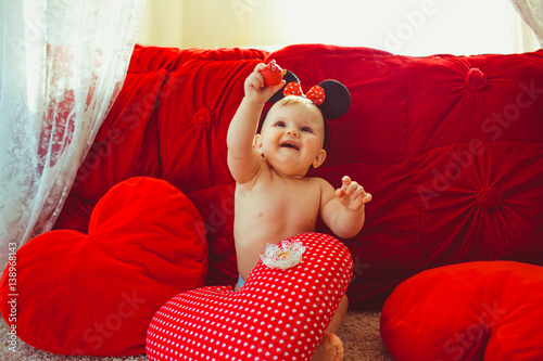 Photography Spotted pillow lies before little girl with Minnie Mouse ears playing before red