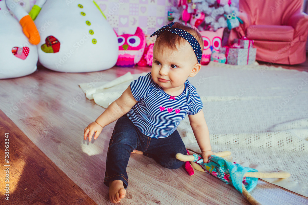 Fototapeta premium Curious little girl creeps around the carpet