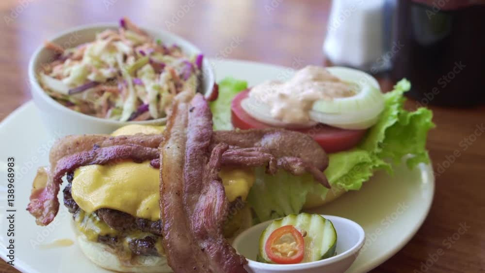 Diner plate, Beef cheese burger with bacon and coleslaw side Diner plate, Beef cheese burger with bacon and coleslaw side