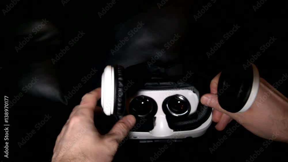 The person wears a virtual reality helmet closeup The person wears a virtual reality helmet closeup