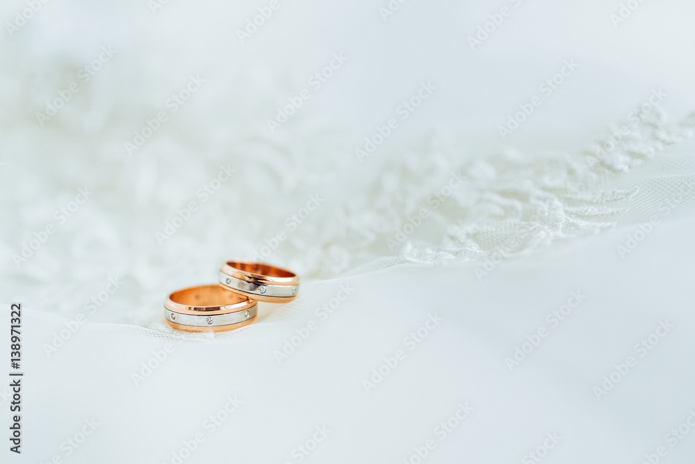 Golden wedding rings on veil. Close-up Golden wedding rings on veil. Close-up