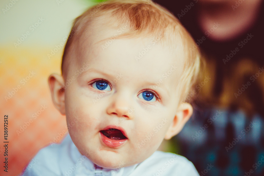 Portrait of pretty little boy with sky blue eyes