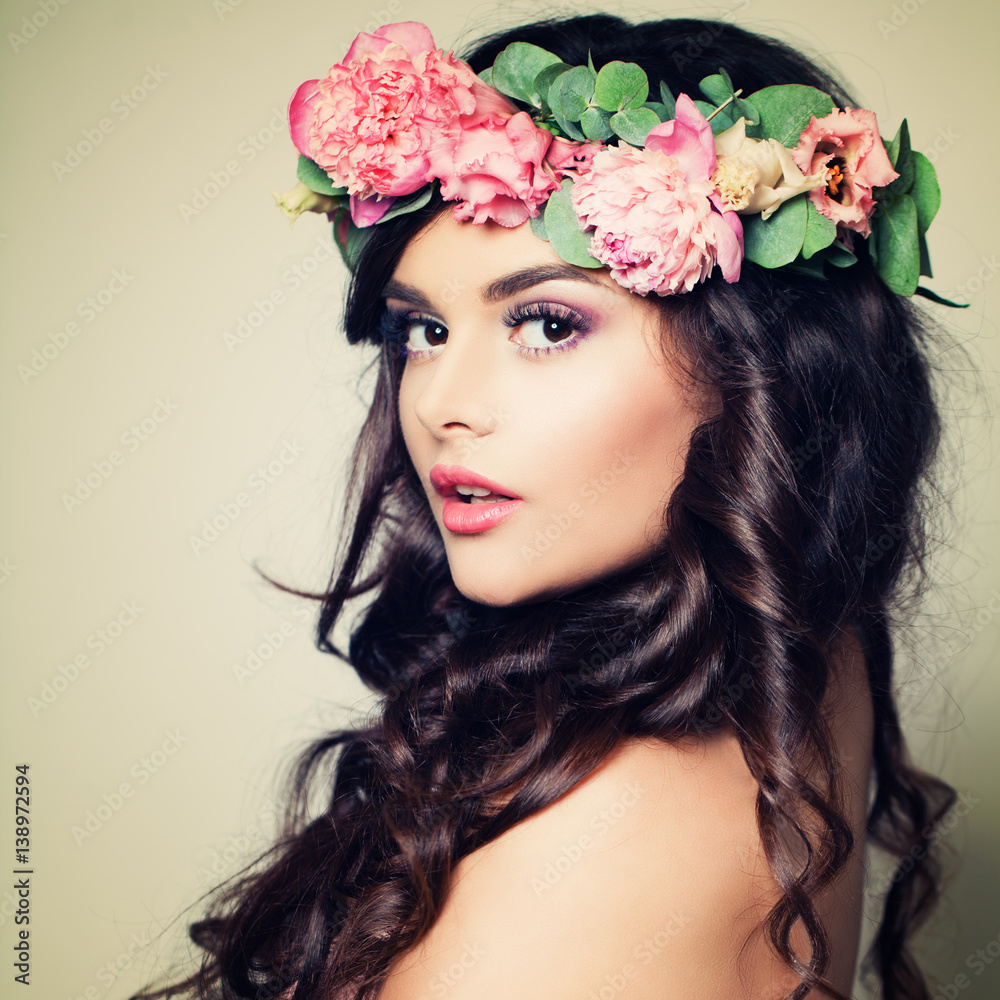 Perfect Model Woman with Makeup, Long Curly Hair and Flowers. Summer Beauty