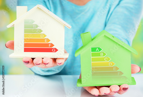 concept comparison between normal house and low consumption house with energy efficiency rating photo