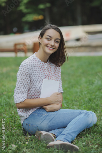 Cute young woman reading the book