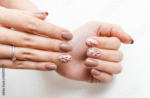 Female hand with nail art isolated on a white background