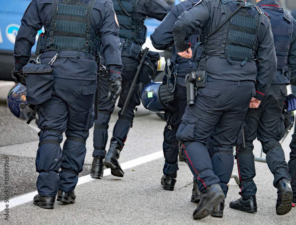 police in riot gear with protective helmet waiting for the fans police in riot gear with protective helmet waiting for the fans