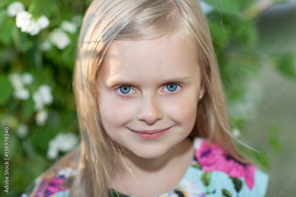 Portrait of a beautiful blonde girl in a summer day, in the city park. Portrait of a beautiful blonde girl in a summer day, in the city park.