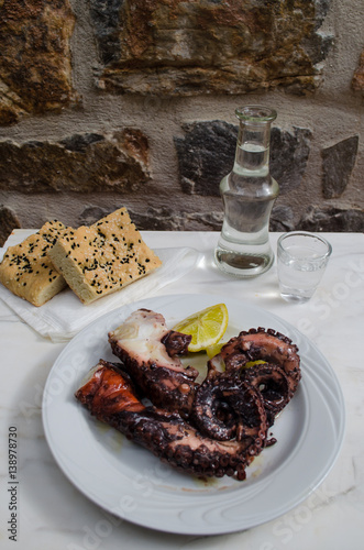 grilled octopus common dish for seafood lovers. Delicious appetizer goes together with ouzo,raki,tsipouro.Tasty recipe for fasting period and lent. photo