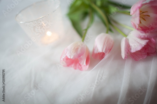 Textile wedding background with pink tulips and candle. woman's day