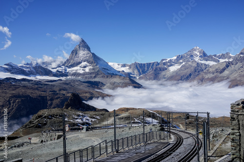 Railway with mountain Matterhorn with clear blue sky and mist below, Zermatt, Switzerland